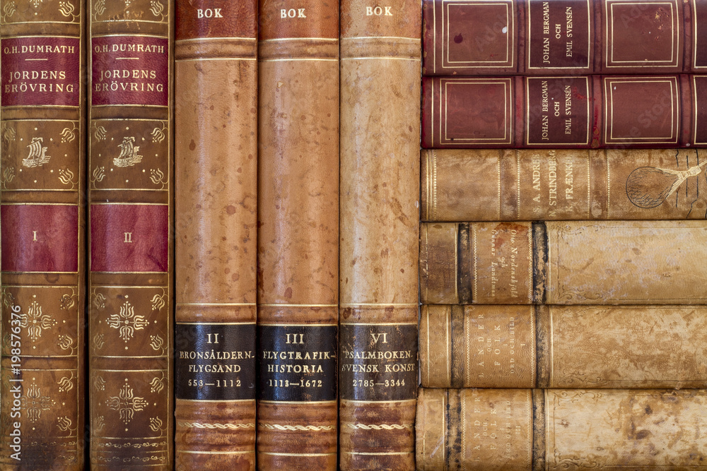 Close up of old books with weathered leather backs Close up of old books with weathered leather backs