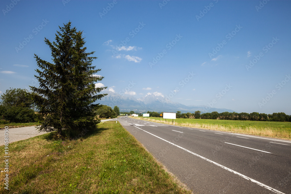 Beautiful scene of the road amoung the yellow grassland mountain and bluesky