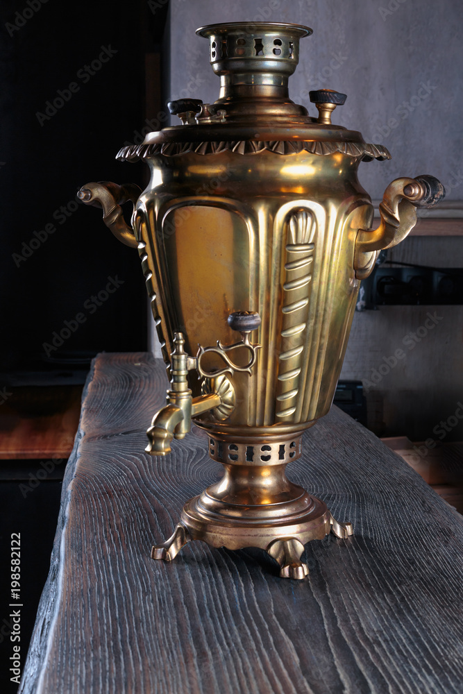vintage samovar on a massive wooden surface with rough handling