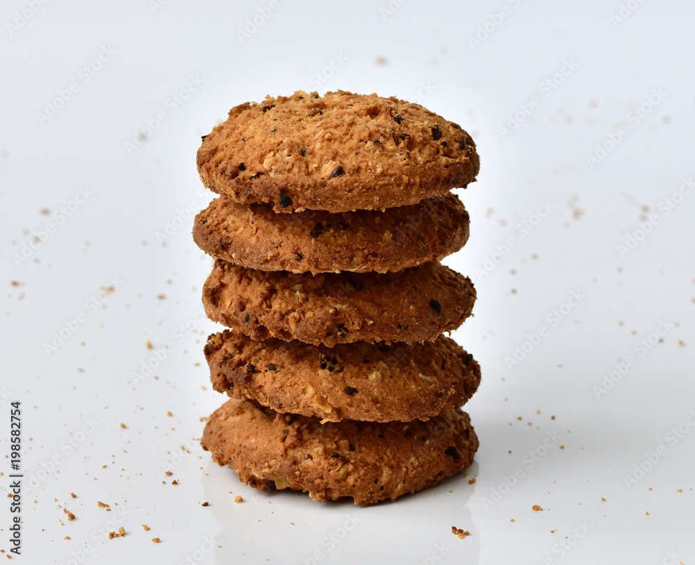 stack of oatmeal cookies on light background and crumbs stack of oatmeal cookies on light background and crumbs