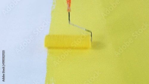The roller is painted yellow on the floor.