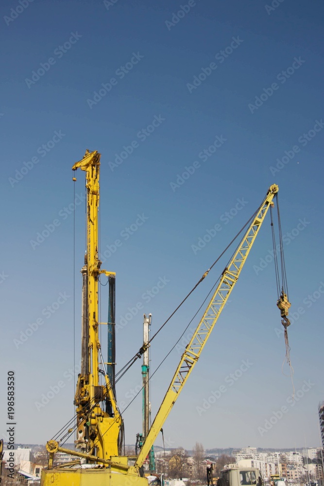 Construction site with high cranes in winter