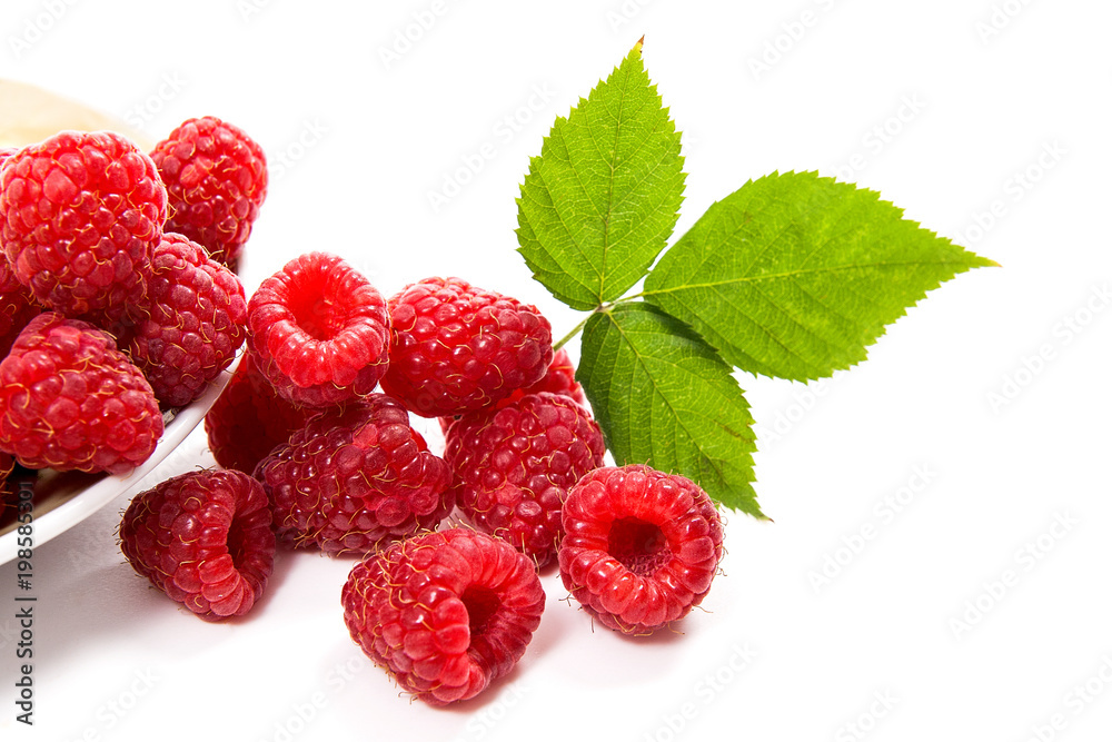 Small plate with ripe raspberries and green leaf isolated on white background.