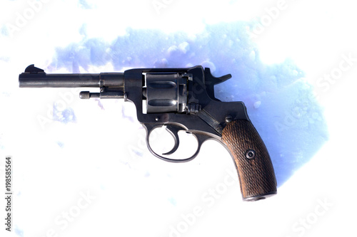 Mini Revolver with wooden grip on the blacket of snow . photo