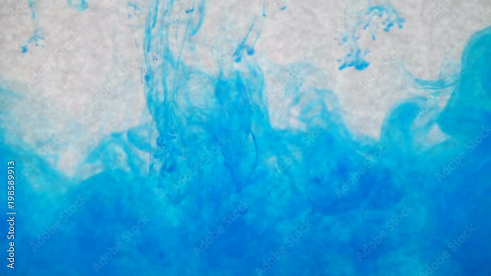 Blue ink in water. Creative slow motion texture. On a white background Blue ink in water. Creative slow motion texture. On a white background
