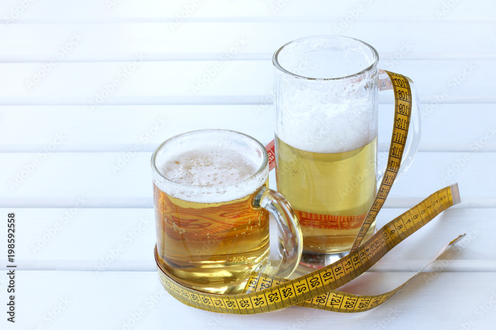 excessive alcohol consumption/ large and small glasses of frothy drink wrapped flexible ruler excessive alcohol consumption/ large and small glasses of frothy drink wrapped flexible ruler