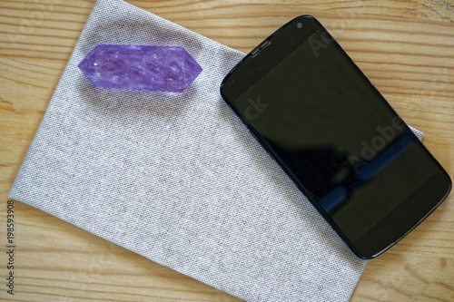Cellphone with crystals on fabric linen surface, luxury business background