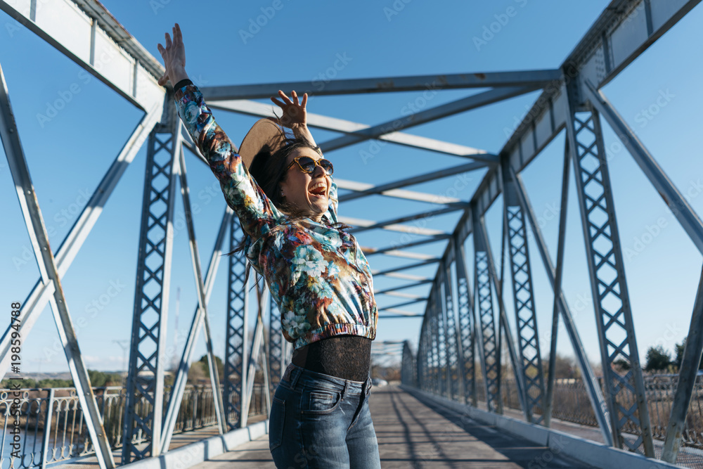  Beautiful girl having fun in the iron bridge
