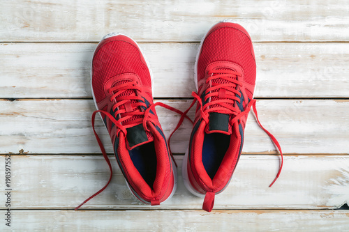 Red running shoe on wood board