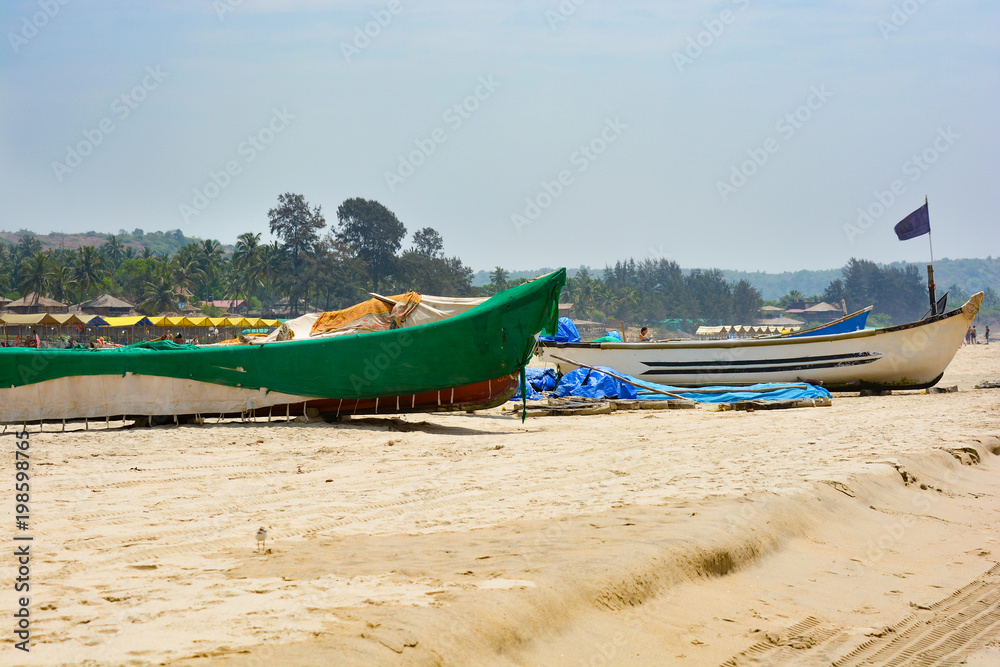 Fototapeta premium Fishing boats on the sand on Arambol beach in North Goa.India