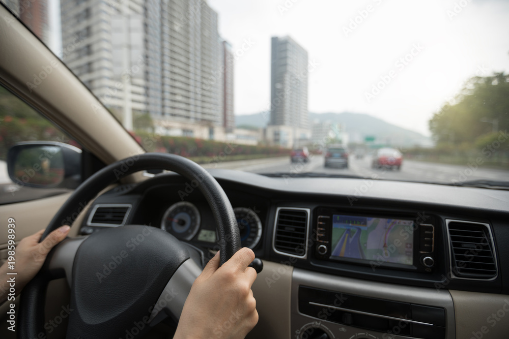 Driving car on city street with GPS navigation