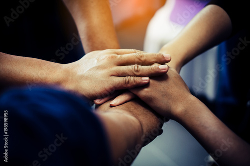 Group of people joining their hands. Teamwork concept.