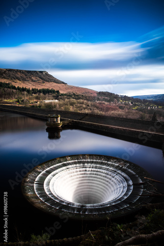 A long exposure of Ladybower reservoir with Bamford edge in the background in the Peak District, Derbyshire, England