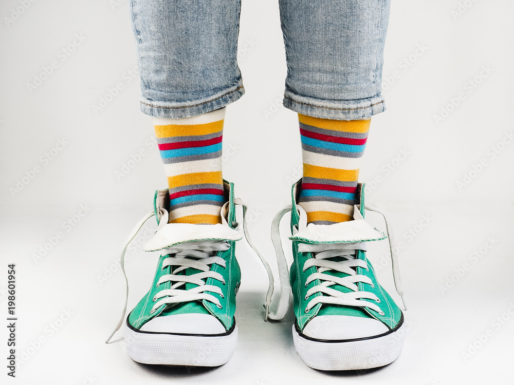 Stylish, bright, green sneakers and funny, happy socks on a white  background. Sport, style, beauty, good mood foto de Stock | Adobe Stock