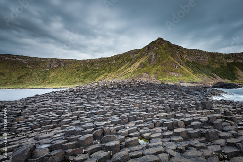 Giant's Causeway caratteristica formazione basaltica esagonale formatasi da antiche eruzioni vulcaniche al tramonto Bushmills Irlanda Europa photo