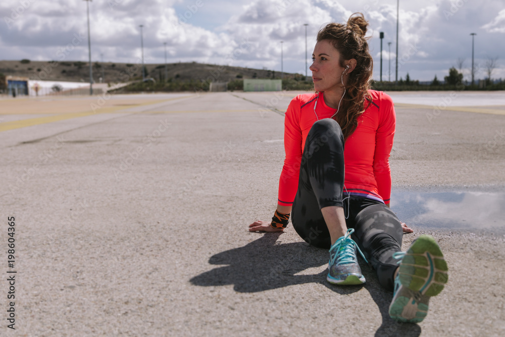 Young woman resiting in the floor after run