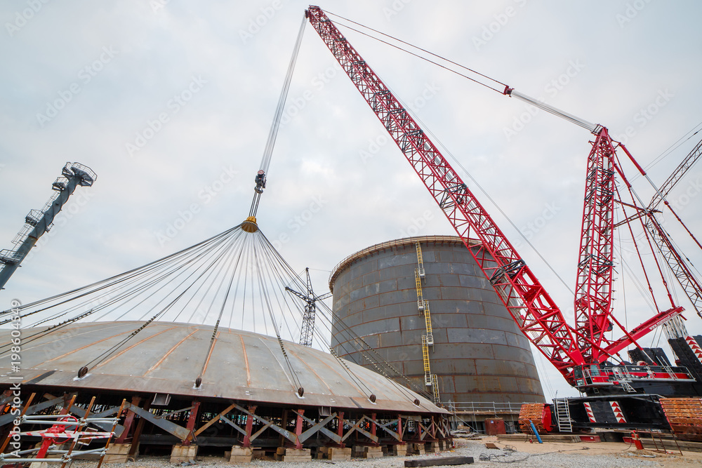 Construction of a production hall at a metallurgical plant factory with the help of a tower crane. Construction of a production hall at a metallurgical plant factory with the help of a tower crane.
