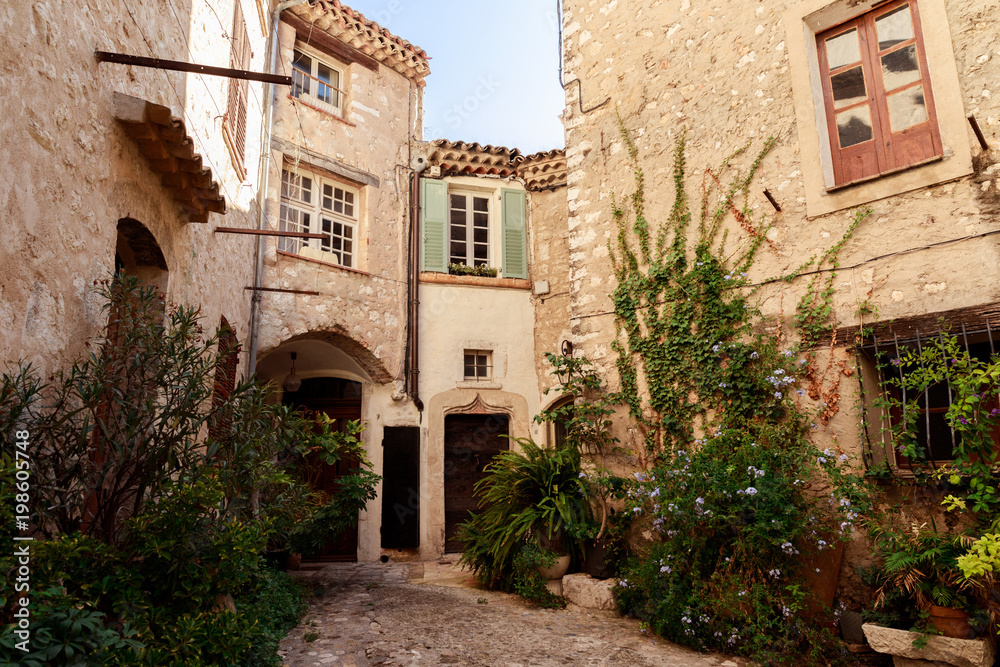 facades of ancient stone buildings at old european town, Antibes, France