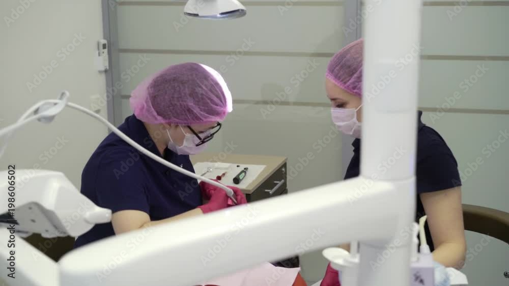 Dentist doctor working with woman patient in dental clinic Dentist doctor working with woman patient in dental clinic