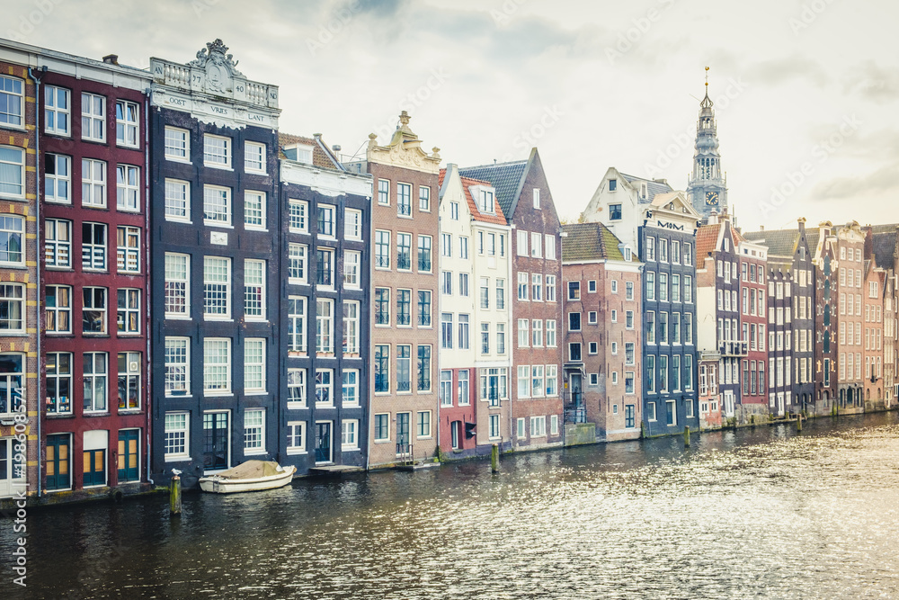 Traditional old buildings in Amsterdam along the canal coast of city center
