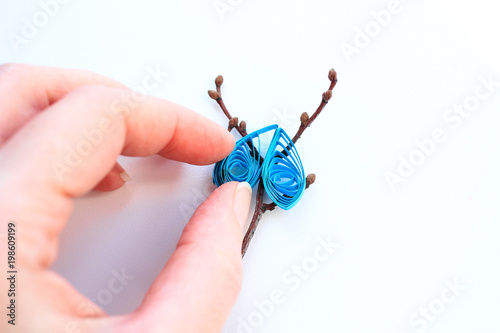 Crafting of twisted blue paper and twigs, quilling