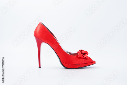 red female shoes with a bow on a white background 