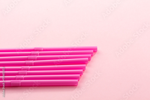 pink drink straws on pastell background photo