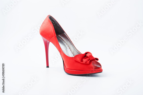 red female shoes with a bow on a white background 