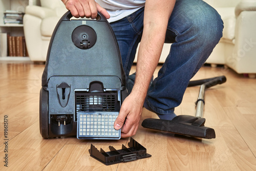 Replacing a hepa filter in vacuum cleaner at home.