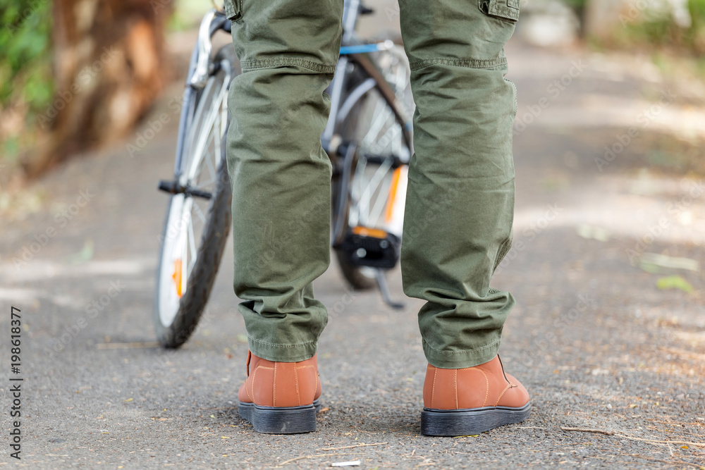 Man wearing cargo pants standing in the nature park Man wearing cargo pants standing in the nature park