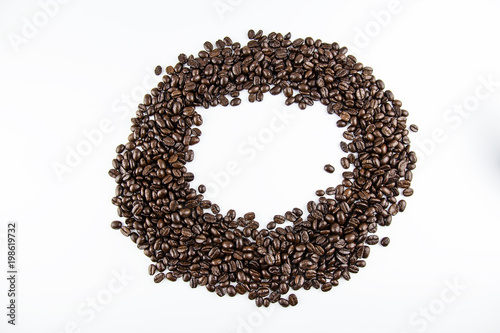 Closeup group of roasted coffee beans on white background.