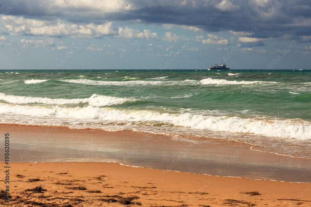 Black sea coast on the horizon ship