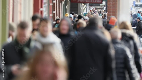 Crowds of people walking down sidewalk in busy town in Utah during festival. photo