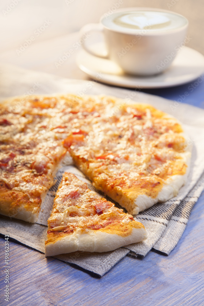 Pizza and Coffee on wooden table, cup of cappuccino. Pizza and Coffee on wooden table, cup of cappuccino.