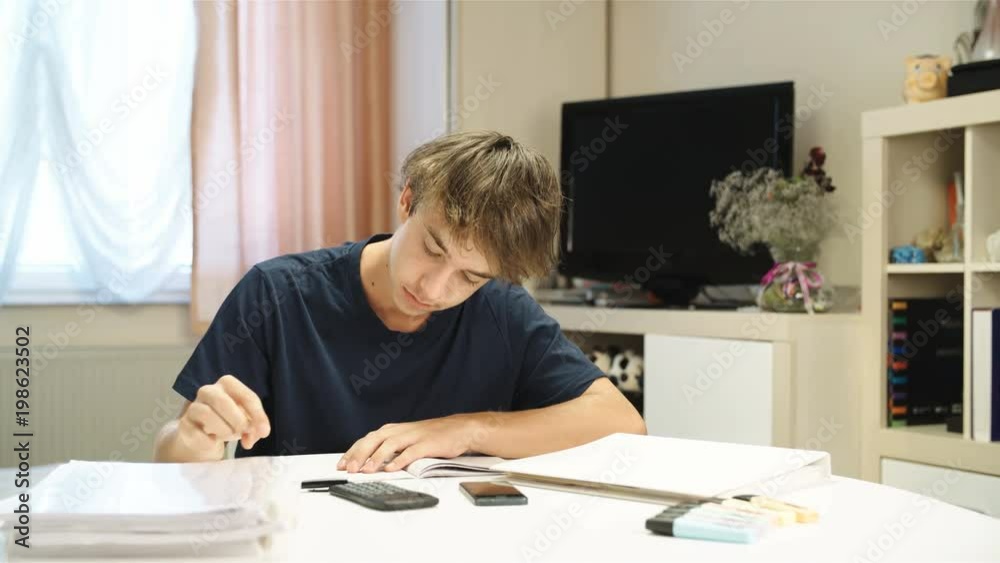 Boy in despair torn out paper while writing homework 4K Boy in despair torn out paper while writing homework 4K