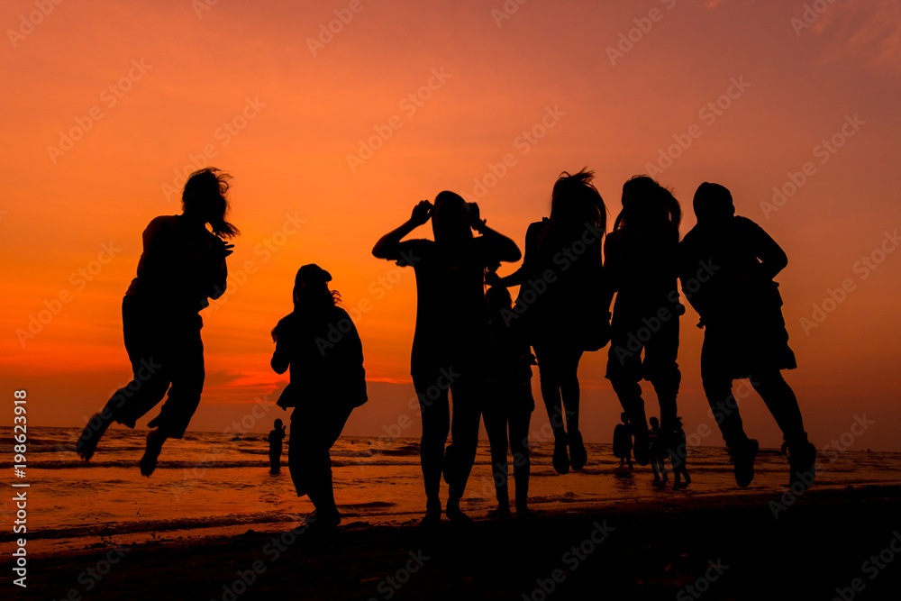Fototapeta premium Woman is walking on the beach relaxing at sunset.