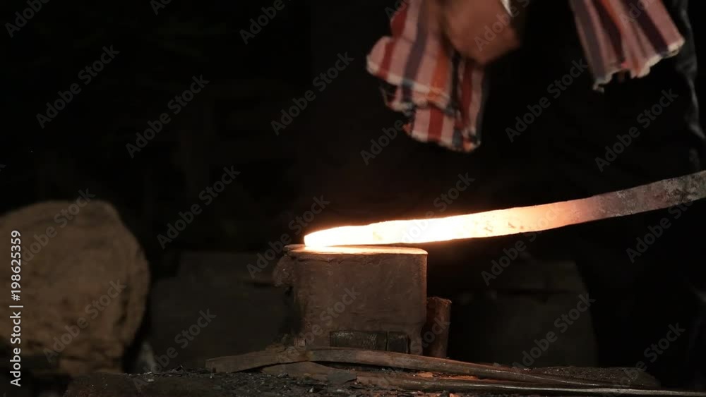 Blacksmith Forging Sword with Sparks in a workshop Blacksmith Forging Sword with Sparks in a workshop