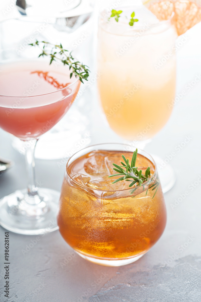 Variety of citrus cocktails on gray surface