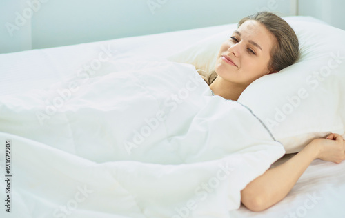 Young beauty asleep in a white bed