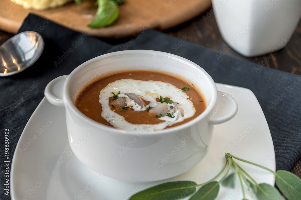 Vegetable cream soup with shrimps in bowl on table Vegetable cream soup with shrimps in bowl on table