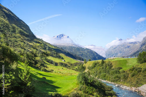 Dolomites Apls, Switzerland panorama. Dolomites Alps landscape, green valley with high mountains and blue sky.