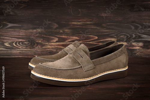 suede men shoes on dark wooden background