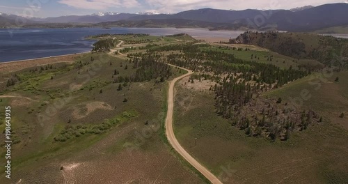 flying high over road back to grand lake granby - Drone Aerial Video 4K Colorado Rocky Mountains, Colorado river, Mountain dam at lake granby,  beautiful water reflection, spring, pristine water