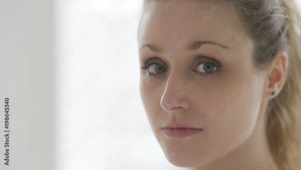 Portrait of young woman looking to camera and smiling Portrait of young woman looking to camera and smiling