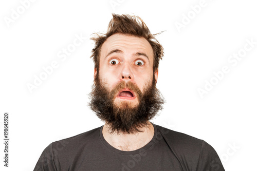Portrait of young bearded man with opened mouth and wide eyes. Guy is surprised. Isolated on white. © vika33