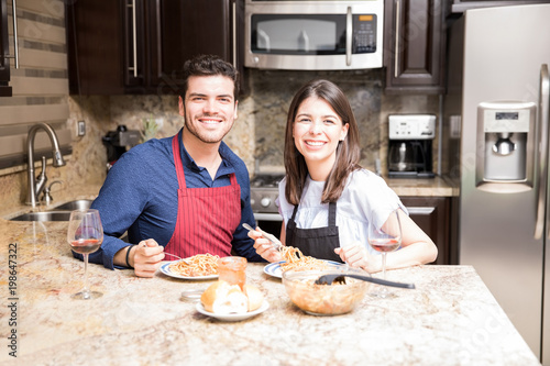 Hispanic couple eating meal at home