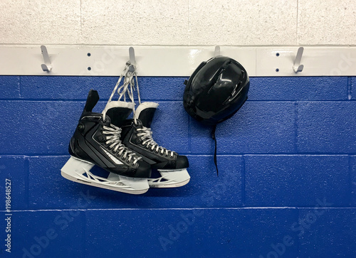 Photography Hockey skates and helmet hanging on locker room with copy space