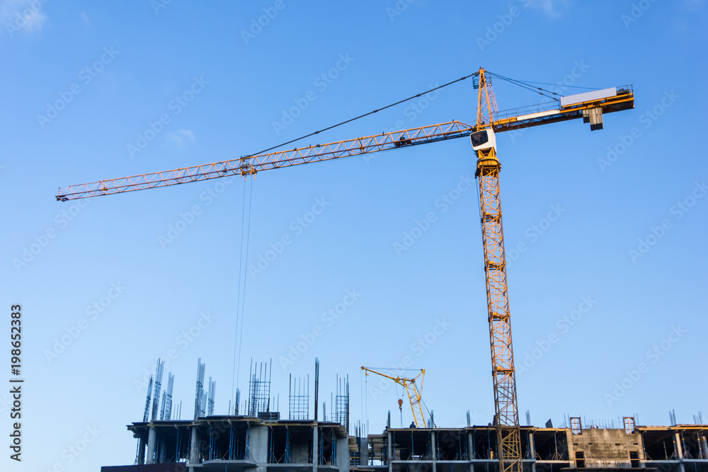 A new building is being constructed with use of tower crane. Jib A new building is being constructed with use of tower crane. Jib