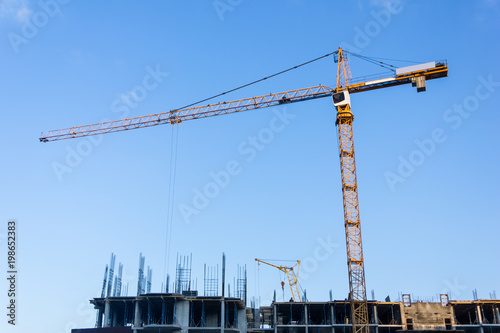 A new building is being constructed with use of tower crane. Jib