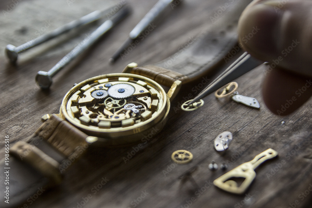 Watchmaker is repairing the mechanical watches in his workshop